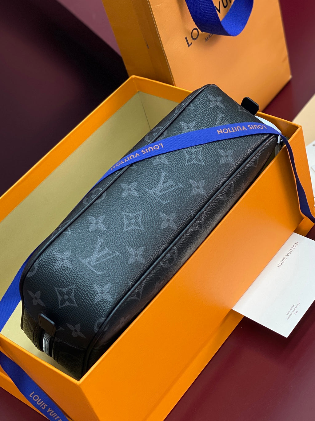 Louis Vuitton monogram small men bag lying in box, dark zip pouch