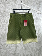 Green Gucci patterned shorts with front pockets and belt loops.