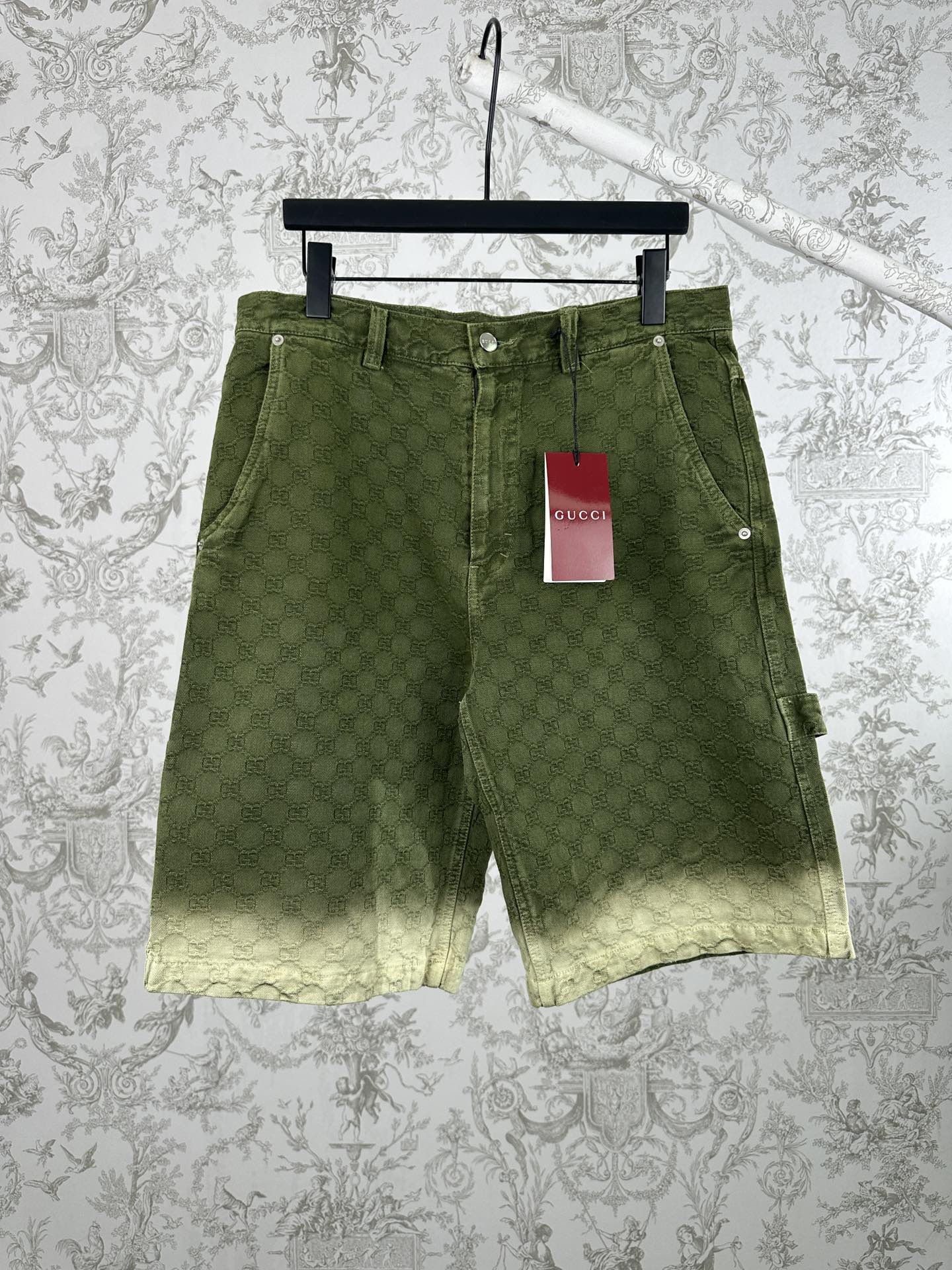 Green Gucci patterned shorts with front pockets and belt loops.