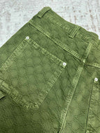 Green Gucci shorts with front cargo pockets and metal buttons.