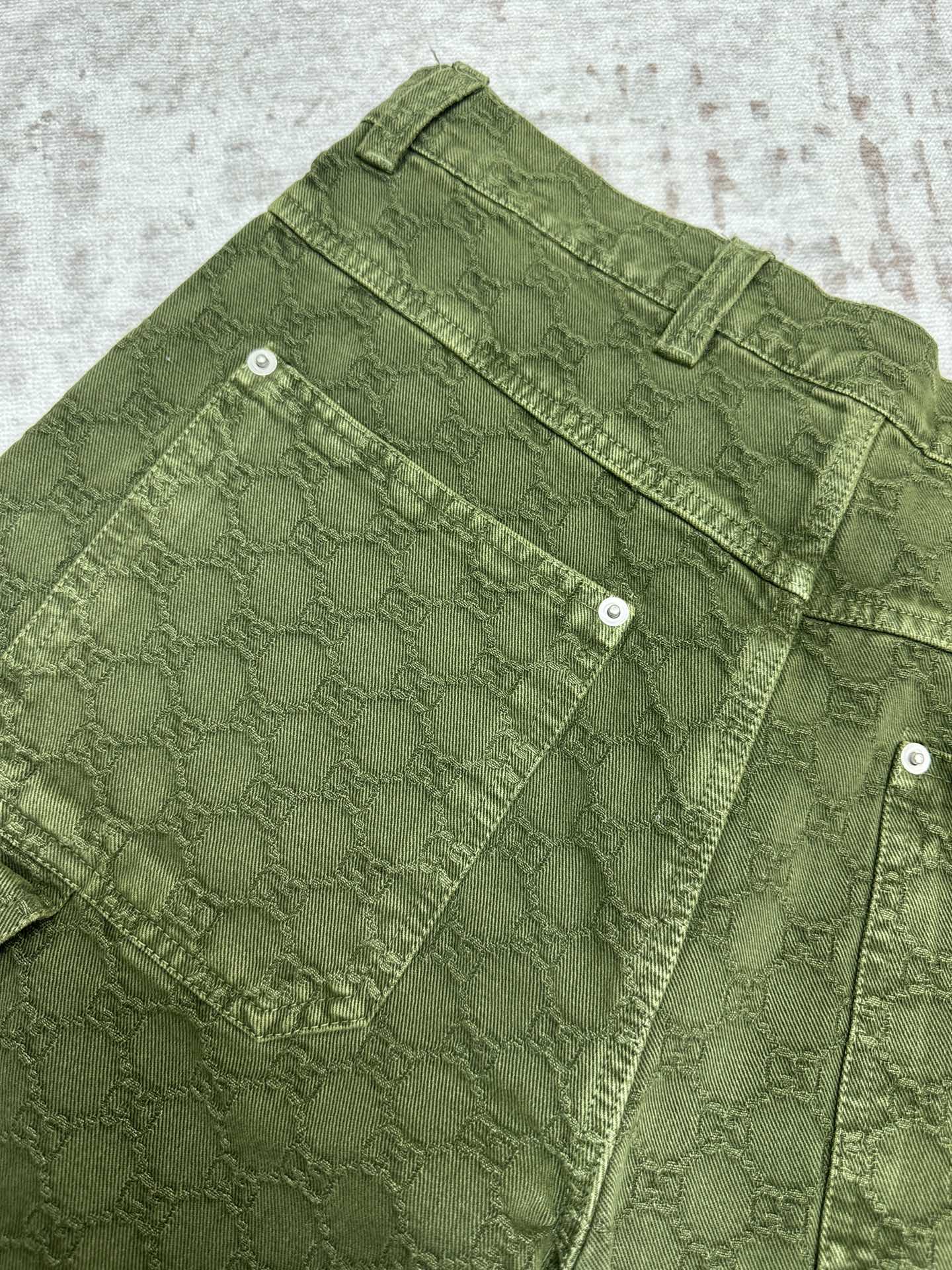 Green Gucci shorts with front cargo pockets and metal buttons.