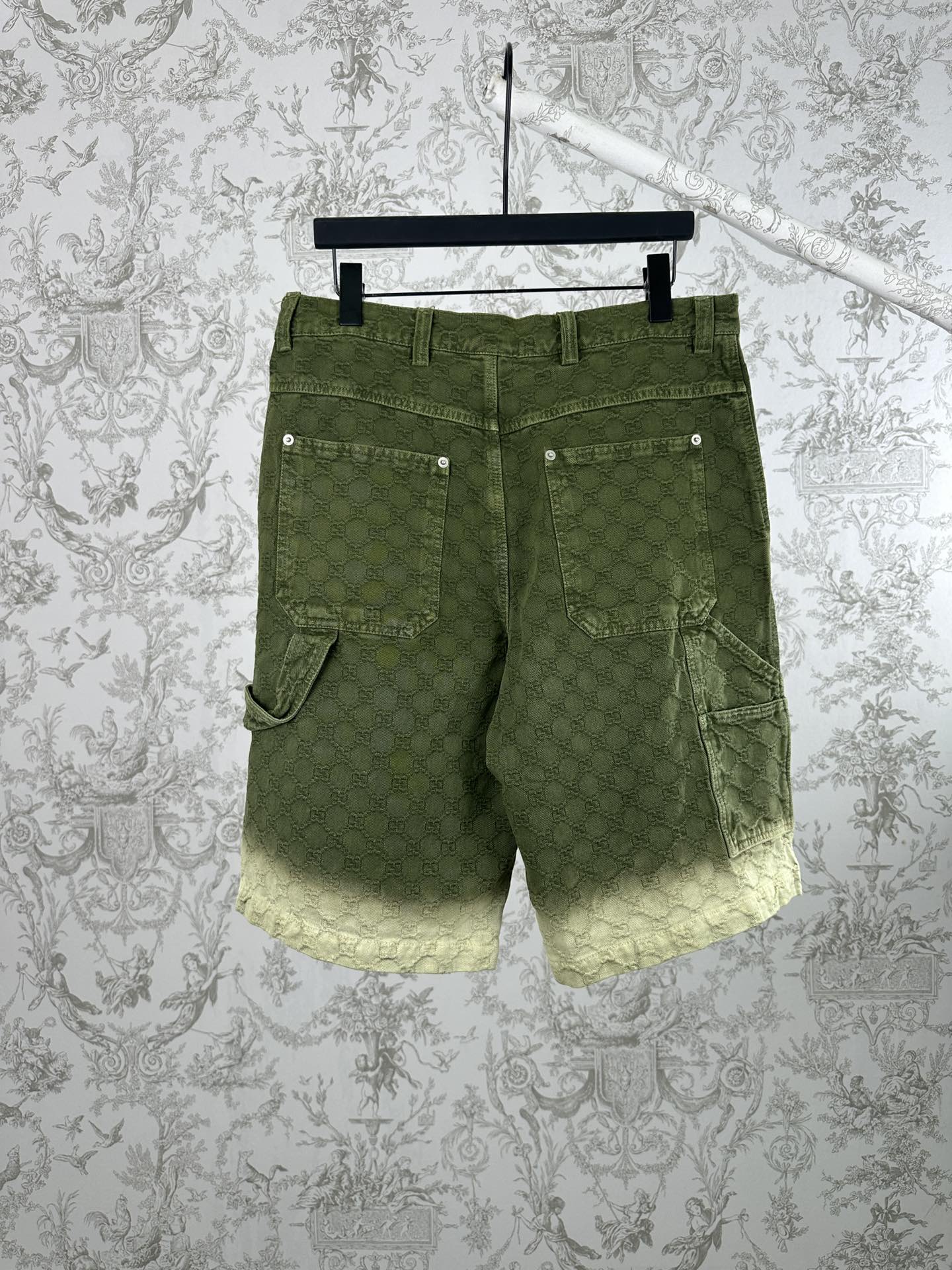 Green Gucci patterned shorts with two front cargo-style pockets.