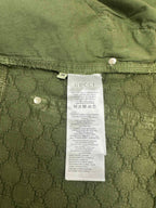 Green Gucci shorts showing care label and interior waistband buttons.