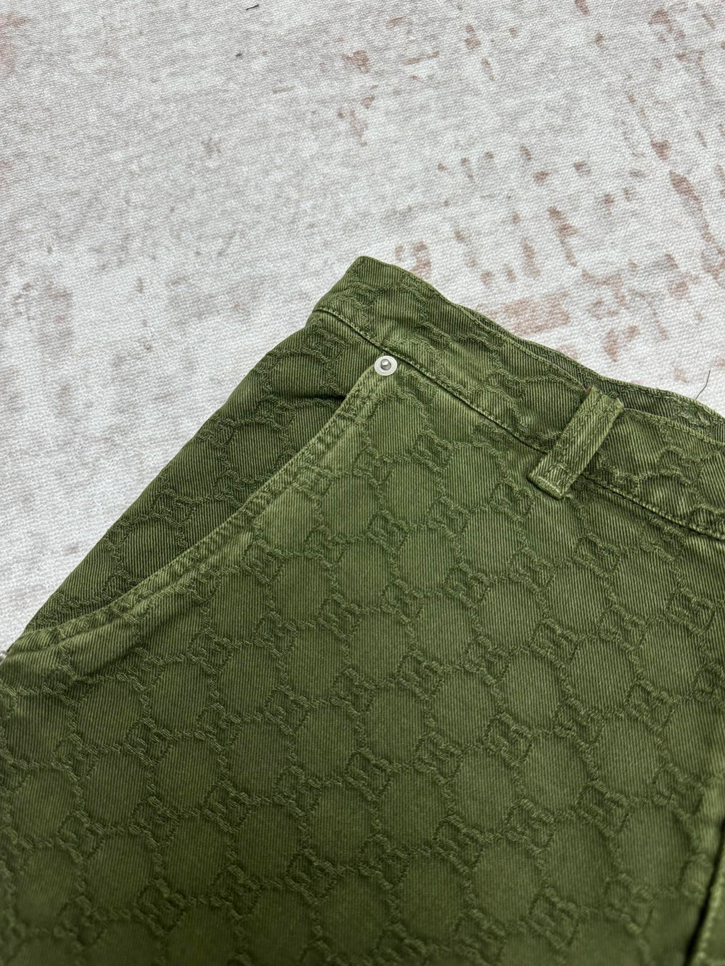 Green Gucci shorts fabric detail with waistband and belt loop.