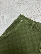 Green Gucci shorts fabric detail with waistband and belt loop.