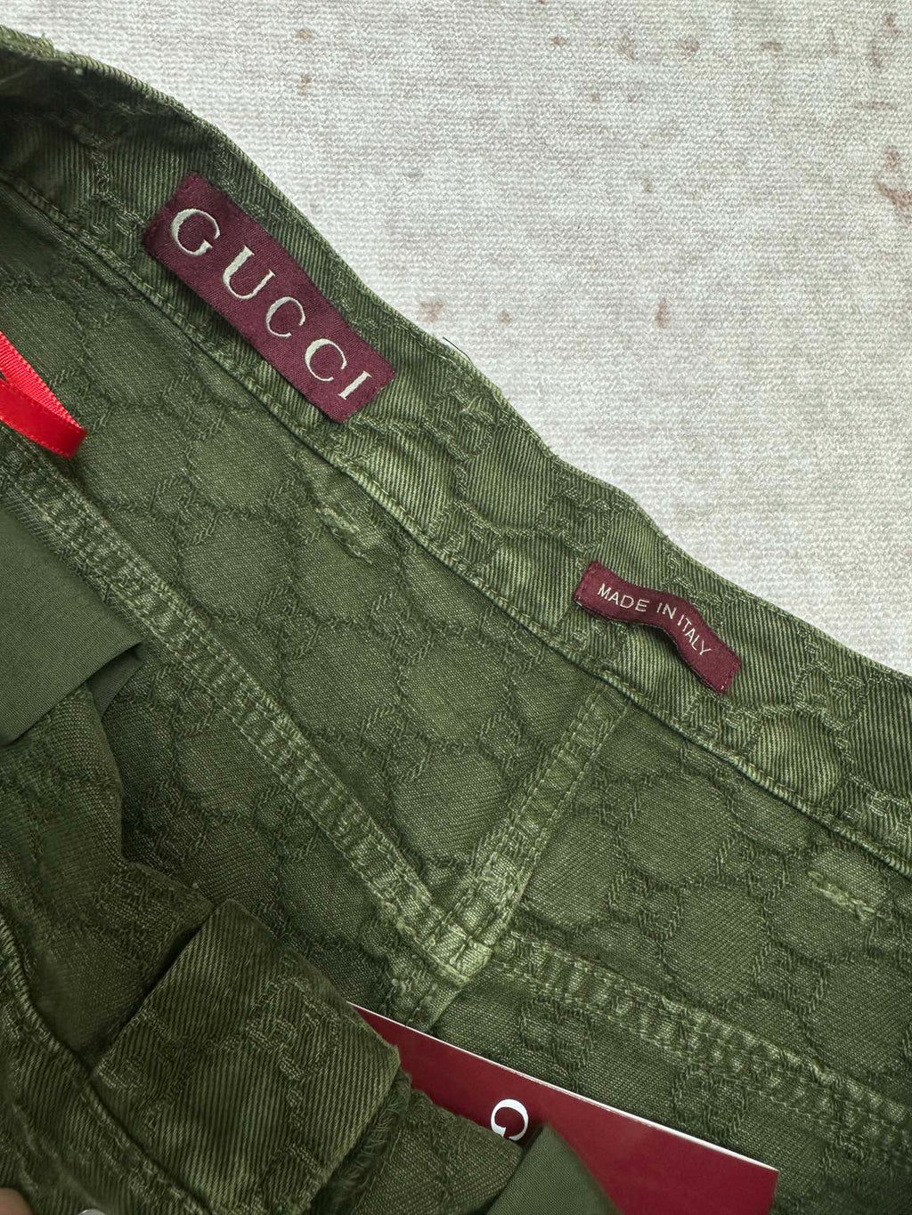 Green Gucci shorts waistband with Gucci logo and Made in Italy label.