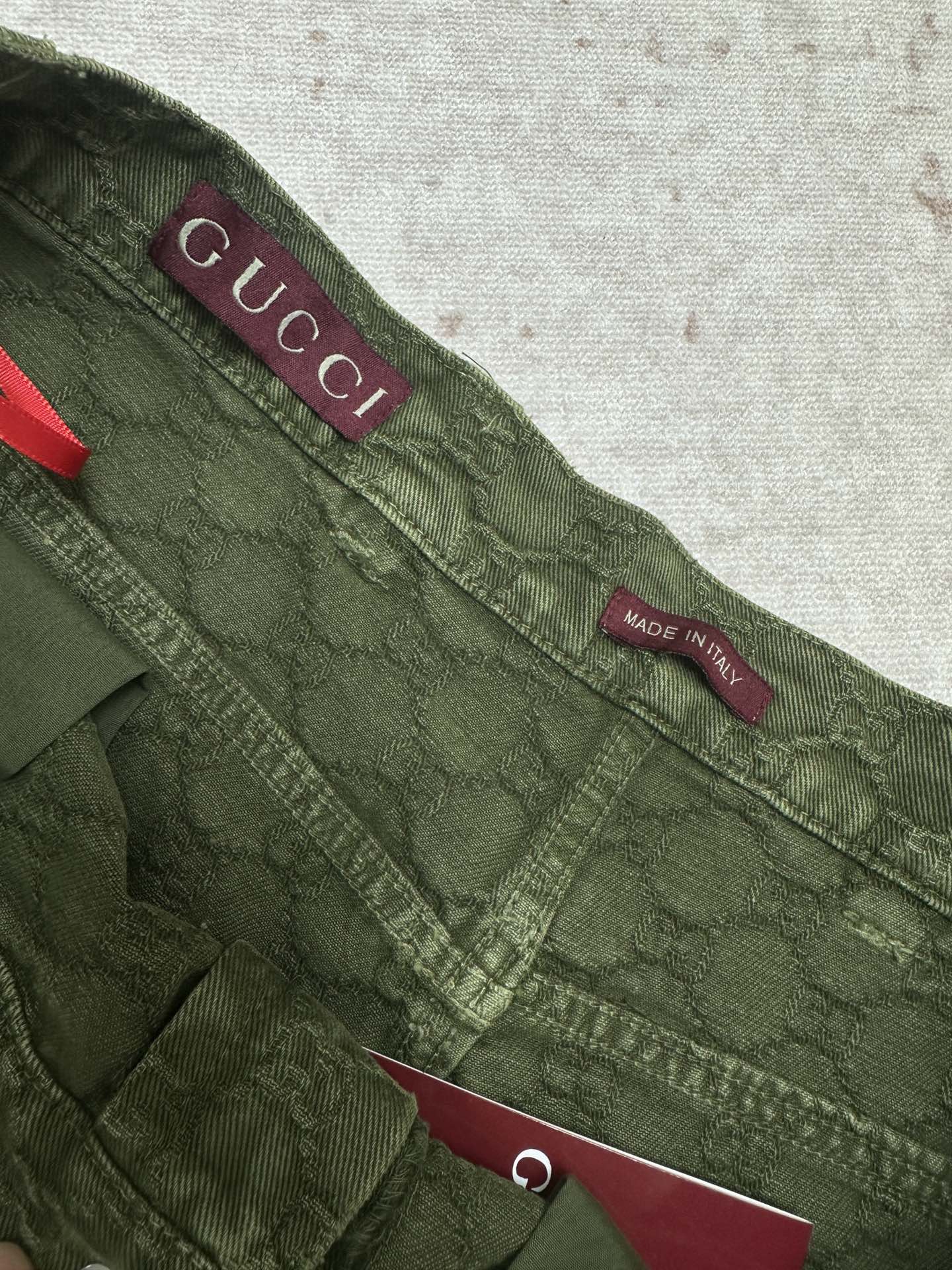 Green Gucci shorts waistband with Gucci logo and Made in Italy label.