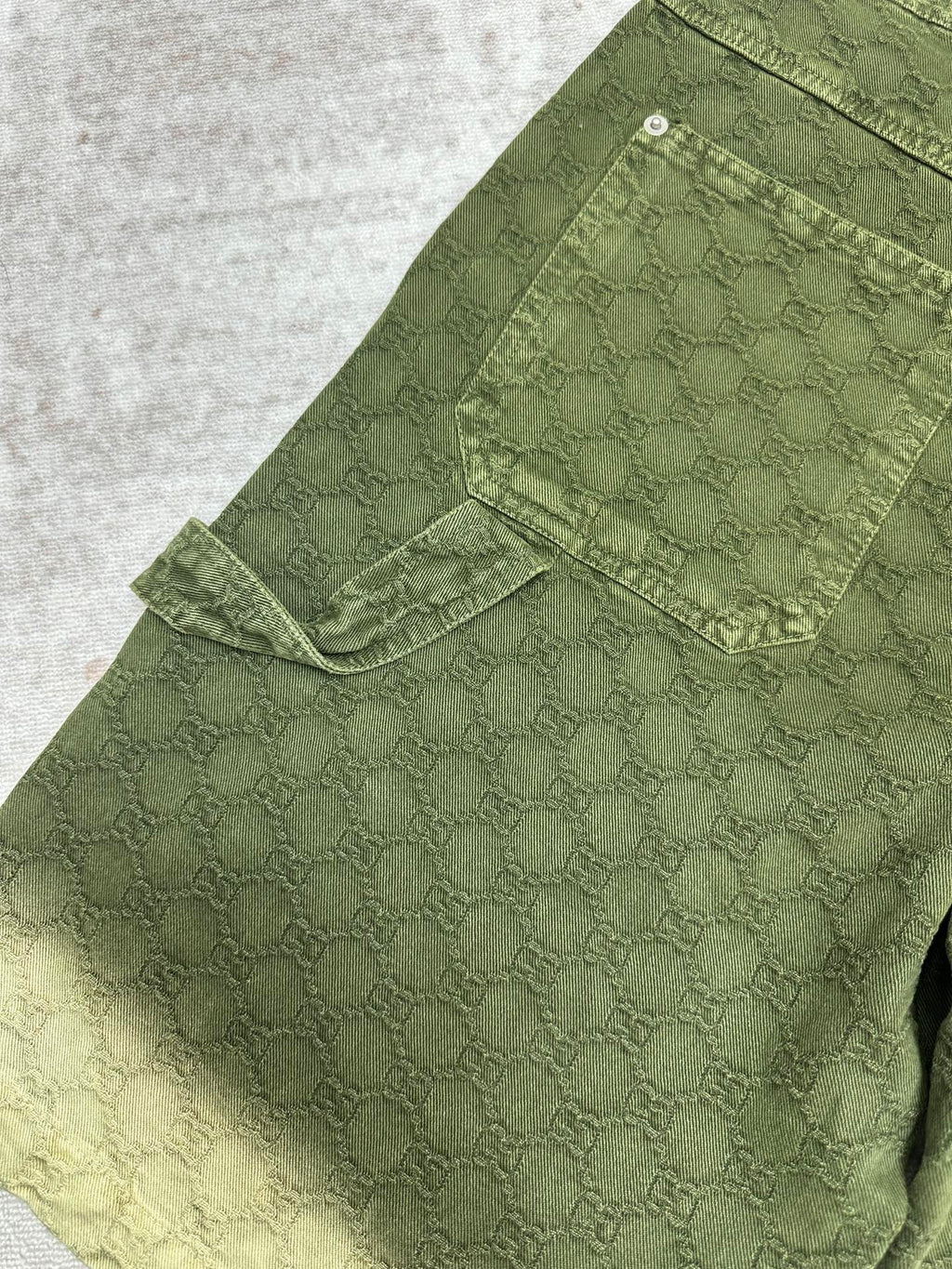 Green Gucci shorts with side flap cargo pocket and stitched panels.