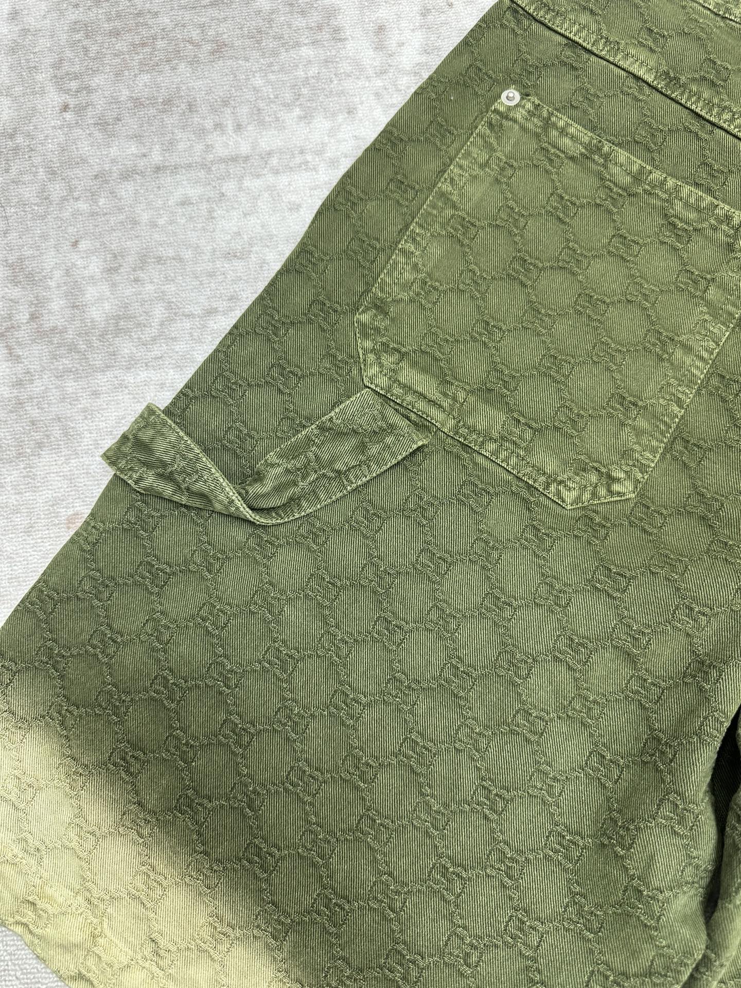 Green Gucci shorts with side flap cargo pocket and stitched panels.