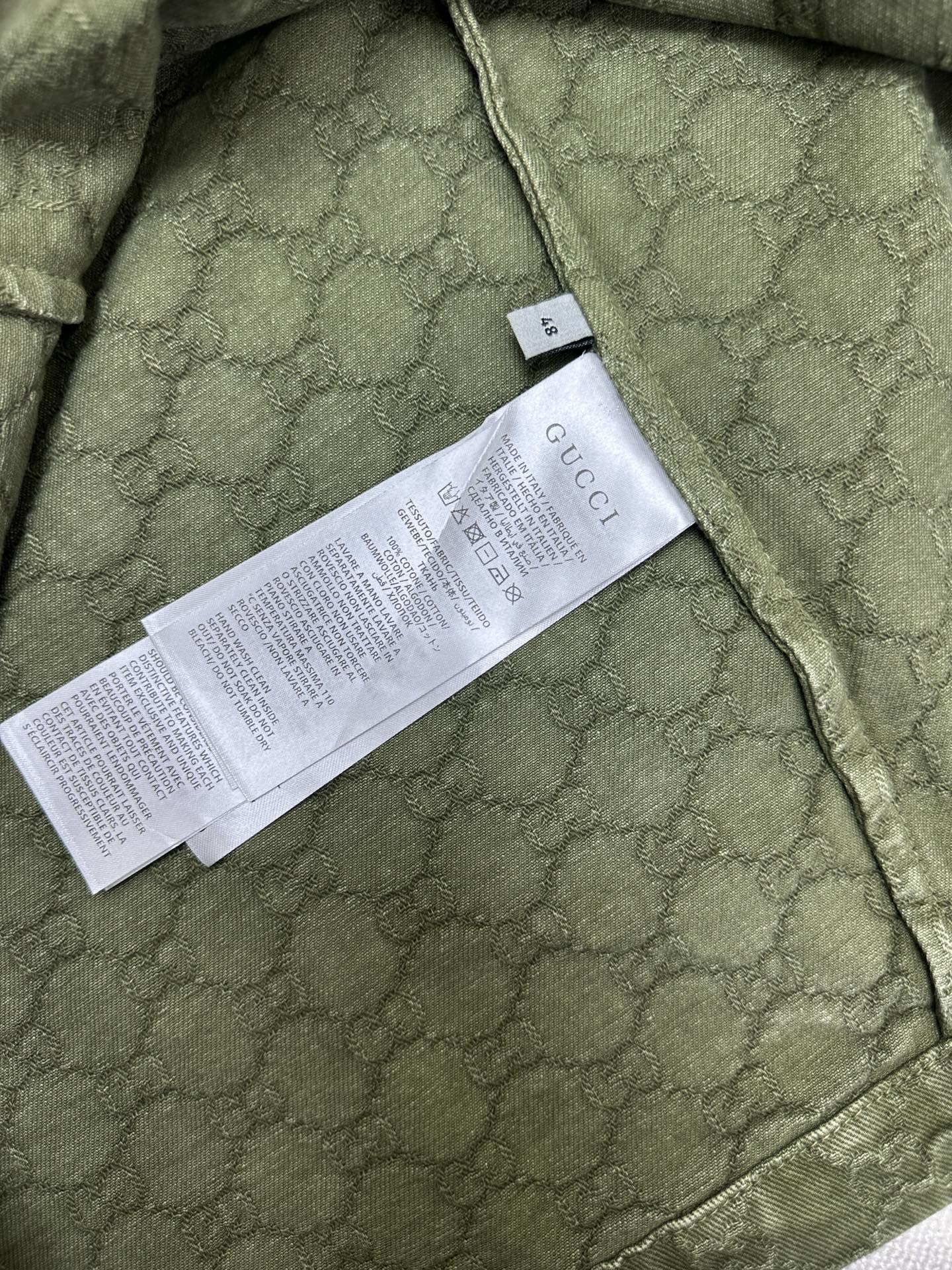 Gucci green short-sleeve shirt with care/size label on inner seam