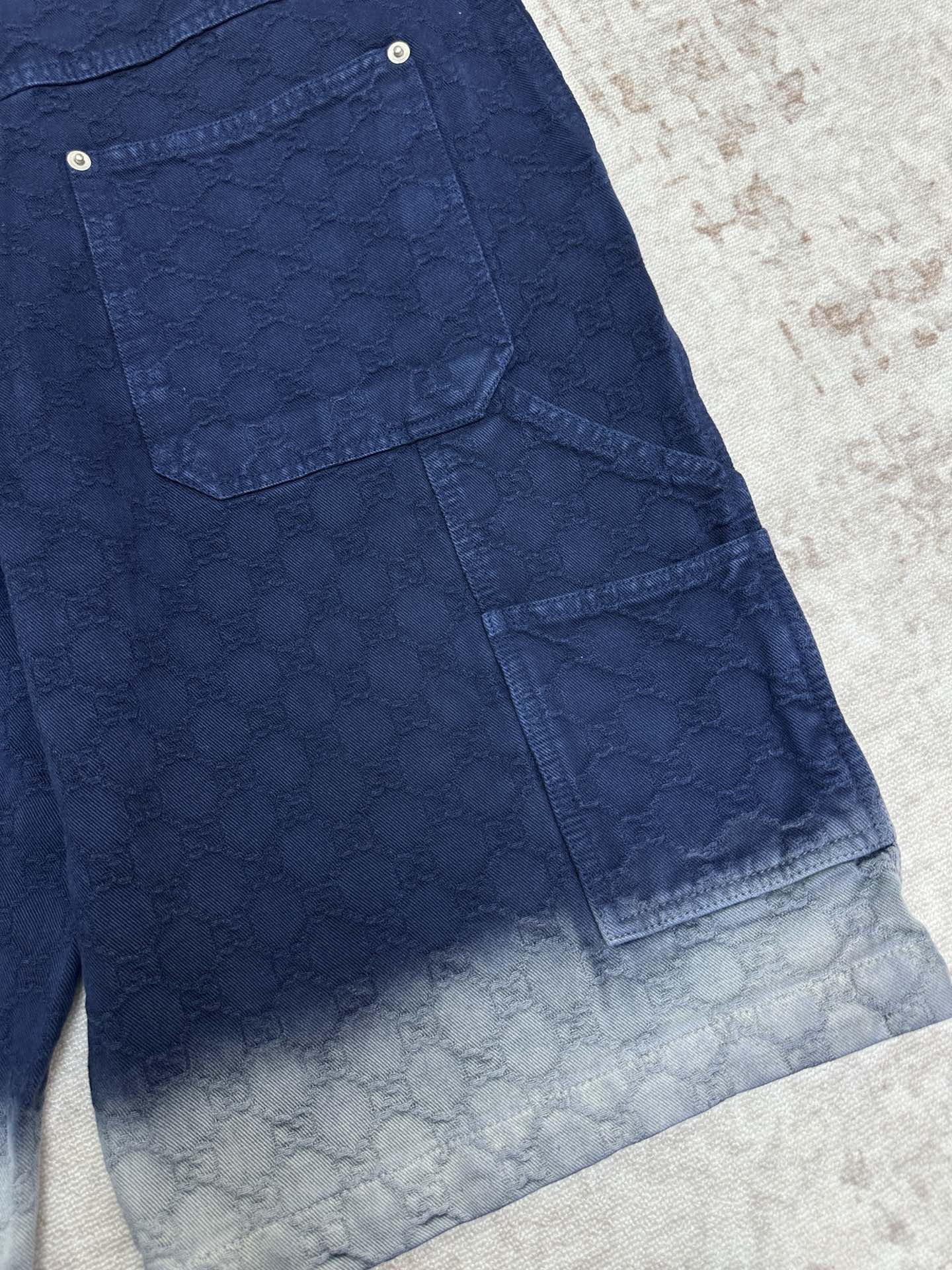 Blue monogram cargo shorts with side flap pocket and light faded hem