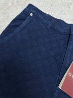 Blue monogram shorts close-up with snap button waistband and belt loops
