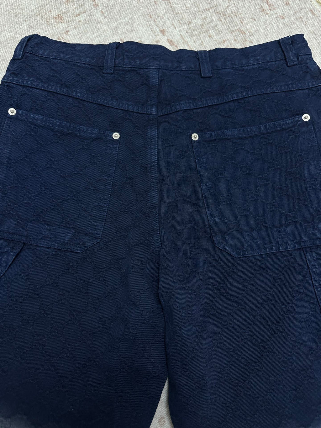 Blue monogram shorts with two back flap pockets and metal snap buttons