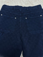 Blue monogram shorts with two back flap pockets and metal snap buttons