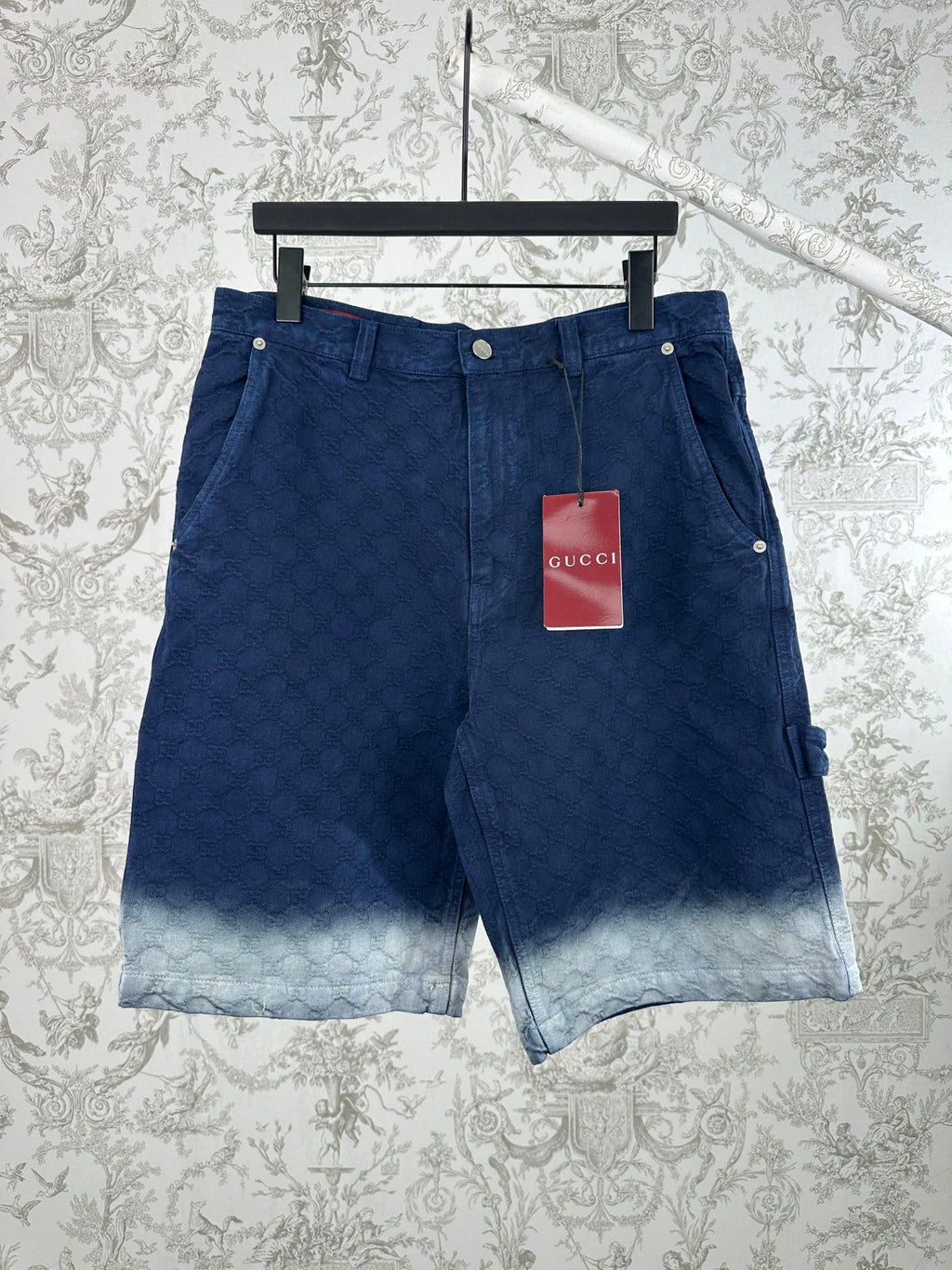 Blue monogram shorts with front button closure and light faded hem