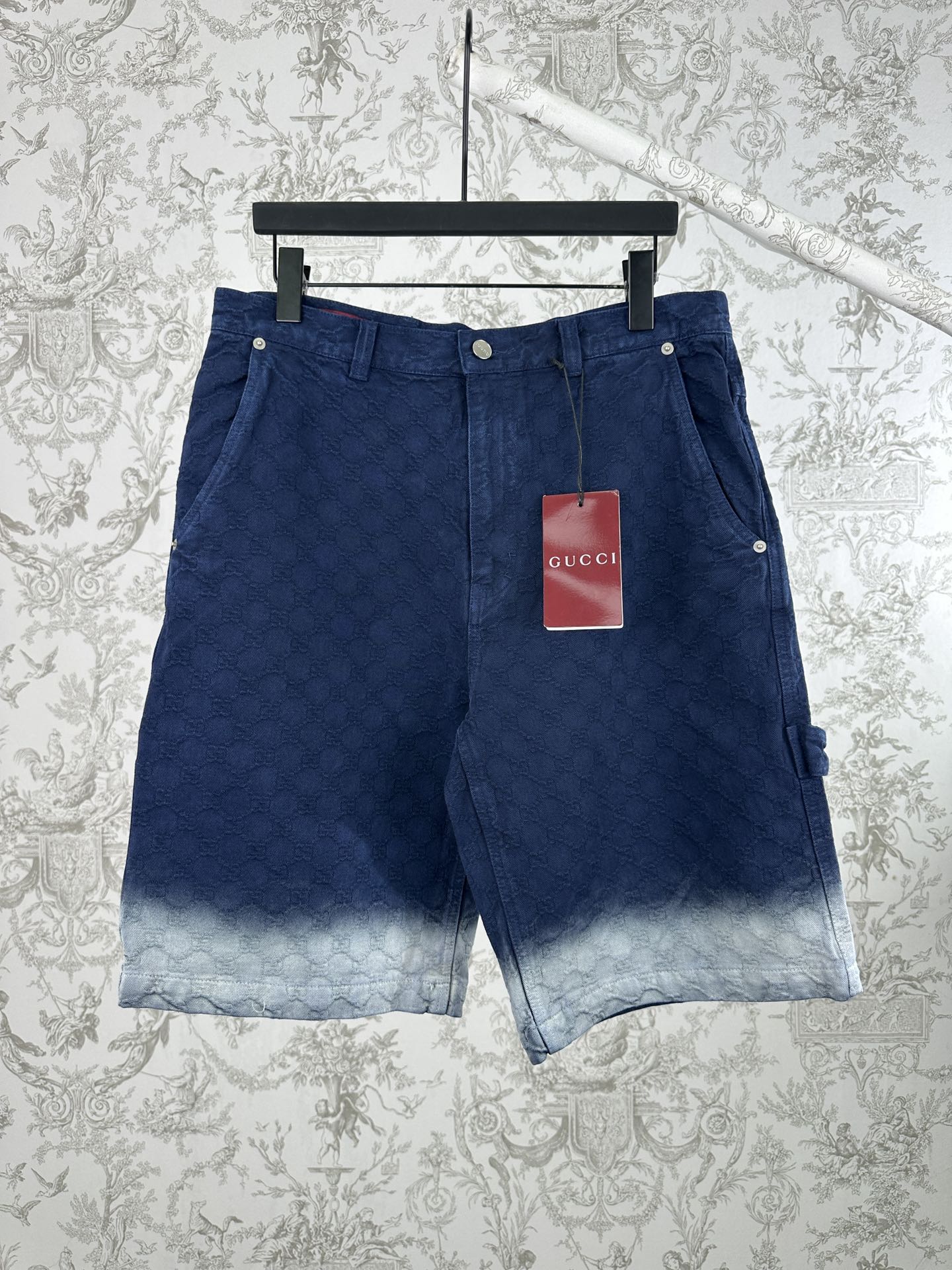 Blue monogram shorts with front button closure and light faded hem