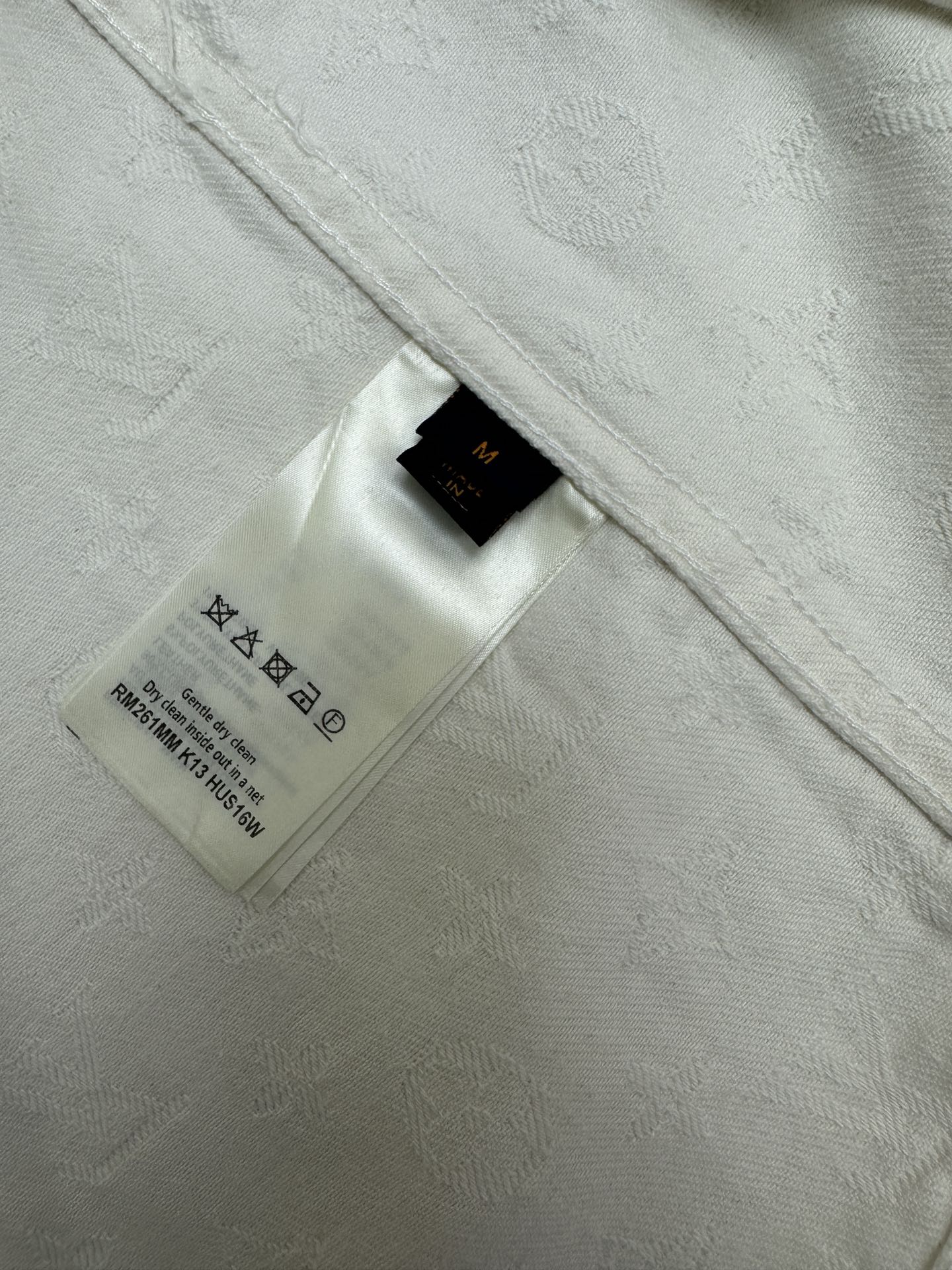 White shirt interior neck label and care tag with printed symbols