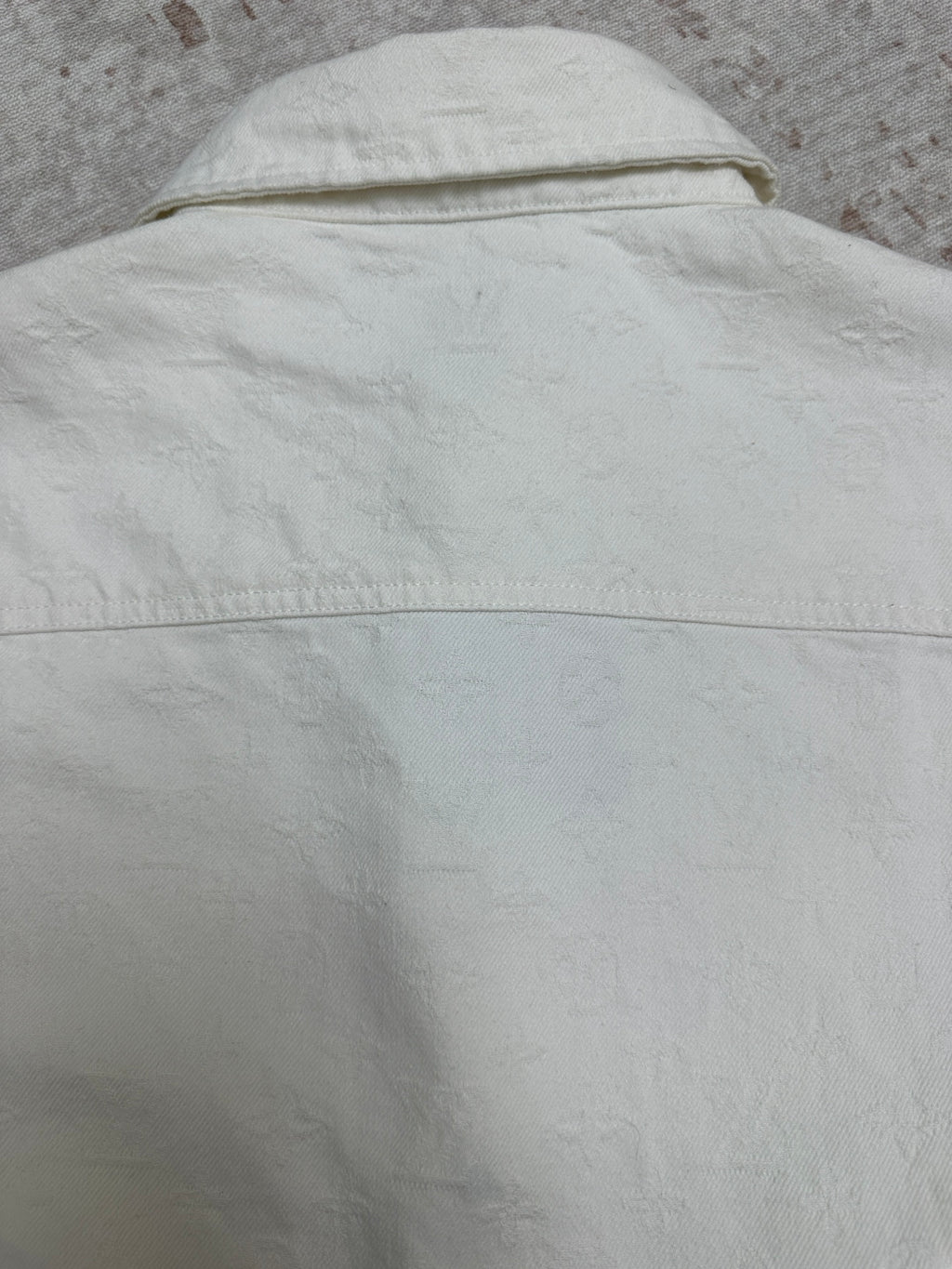White shirt upper back with stitched yoke seam and curved shoulder line