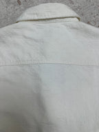 White shirt upper back with stitched yoke seam and curved shoulder line