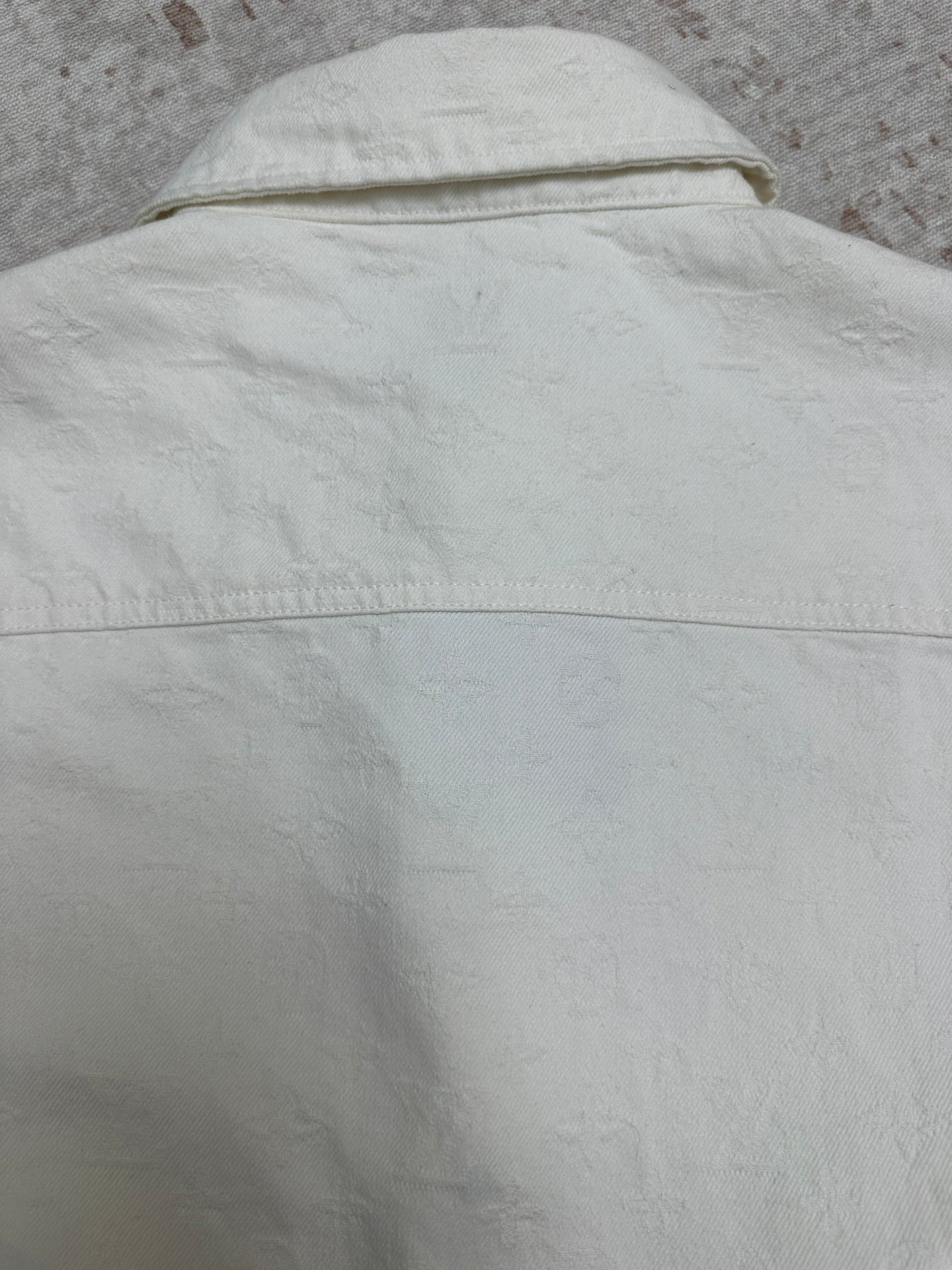 White shirt upper back with stitched yoke seam and curved shoulder line