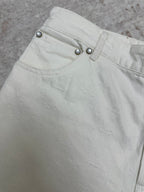 White shorts waistband close-up with metal button details