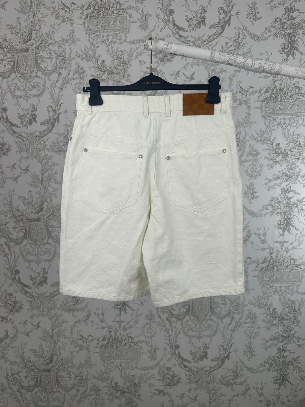White shorts with belt loops and buttoned front pockets