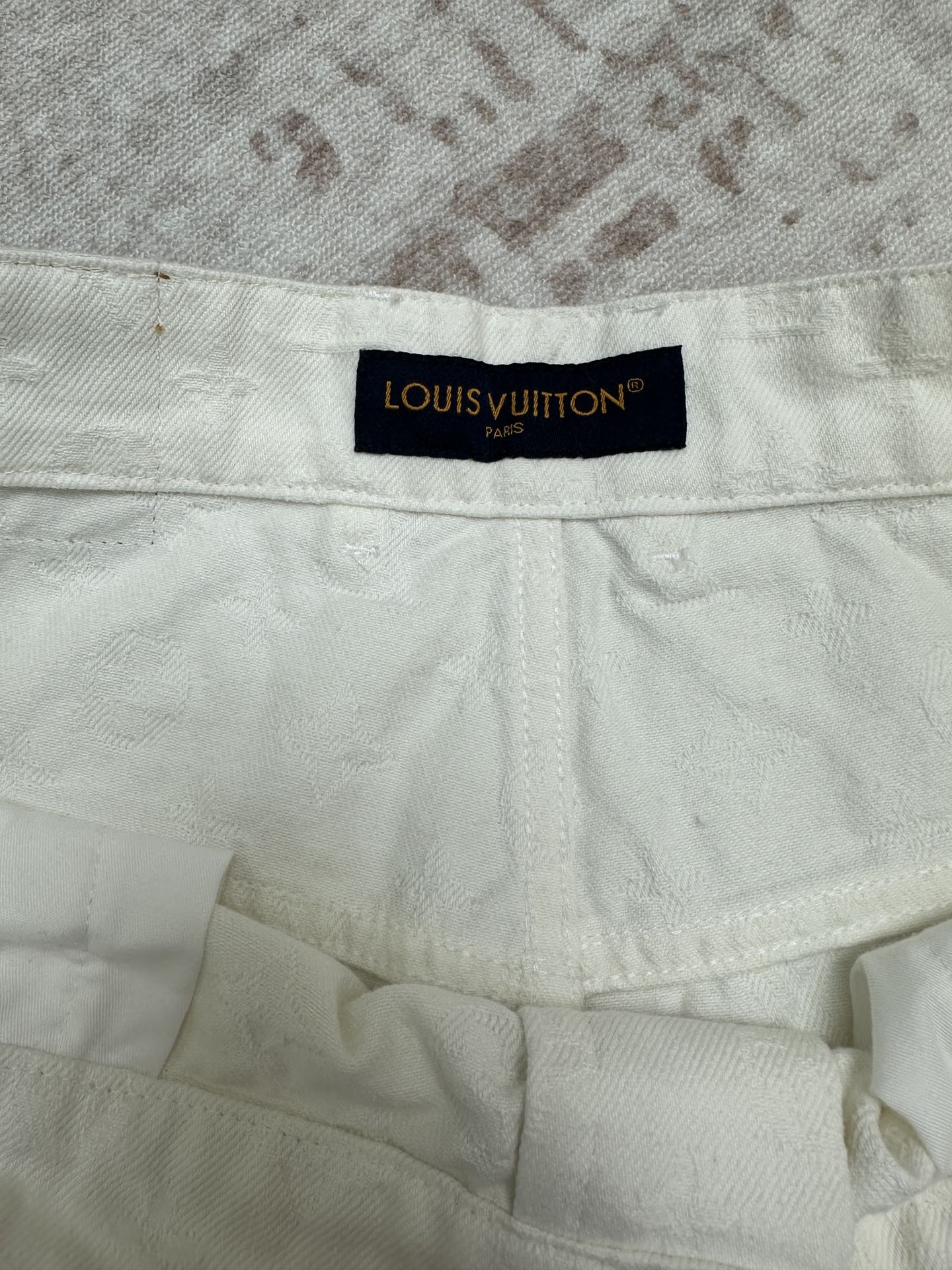 White shorts inner waistband with Louis Vuitton fabric label
