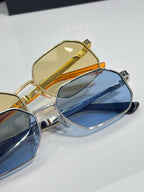 Versace sunglasses close-up: gold frame with yellow lens and blue lens pair.