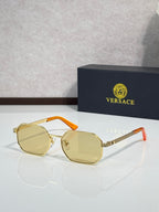Versace sunglasses with gold frames and yellow tinted lenses, orange accents.