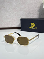 Versace sunglasses with gold frames and dark olive tinted lenses.