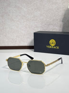Versace sunglasses with gold frames and dark lenses with octagonal shape.
