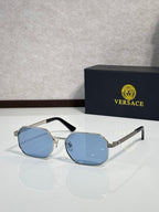 Versace sunglasses with silver frames and light blue tinted octagonal lenses.