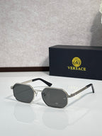 Versace sunglasses with silver frames and dark octagonal lenses.