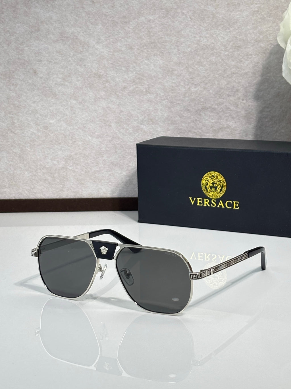 Versace sunglasses with black frame and dark gray lenses, shield-like square silhouette