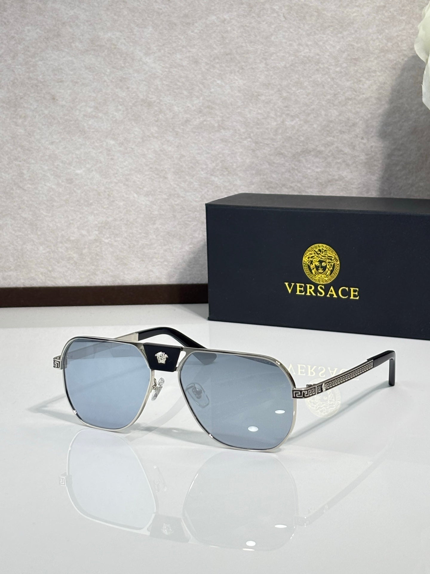 Versace sunglasses with black frame and blue mirrored lenses, square shape