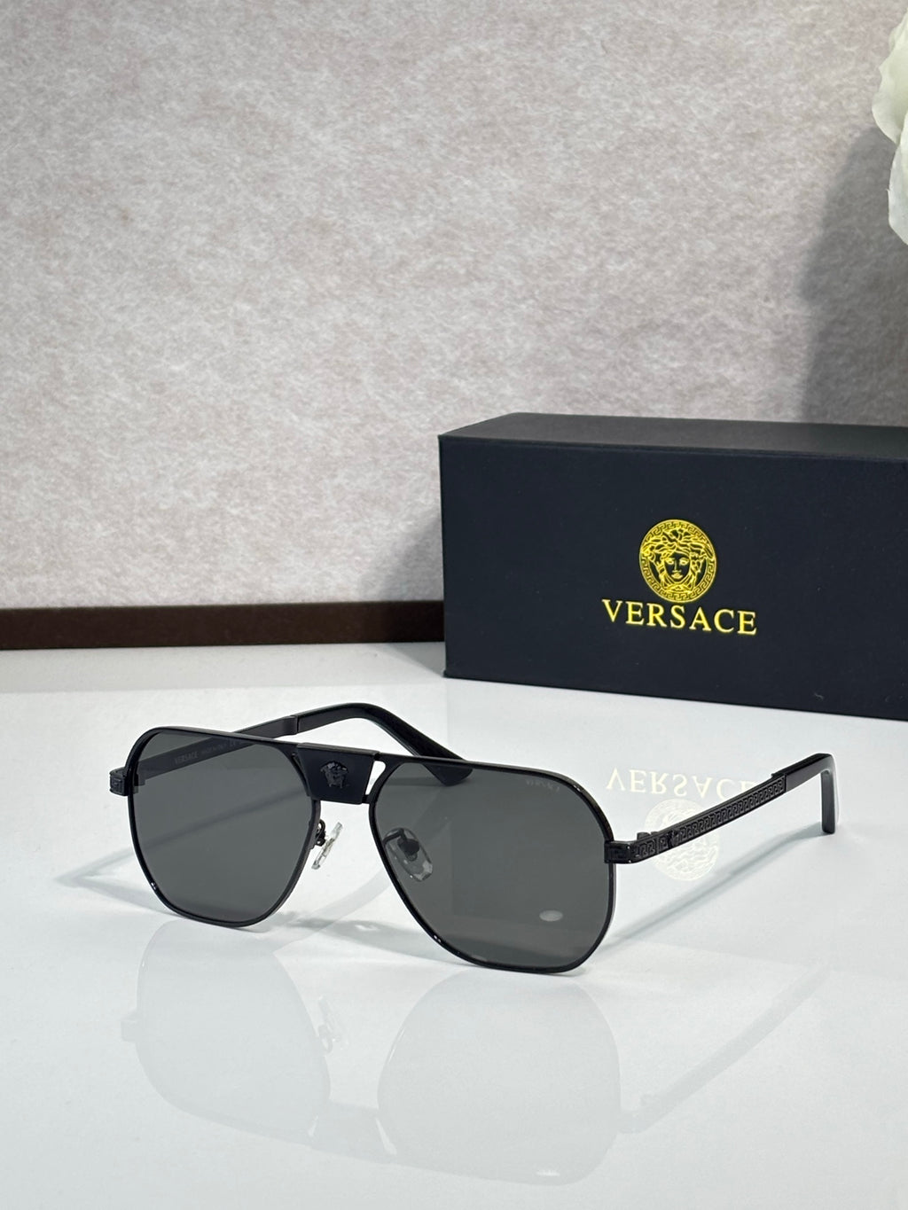 Versace sunglasses with black frame and dark lenses, square shield silhouette