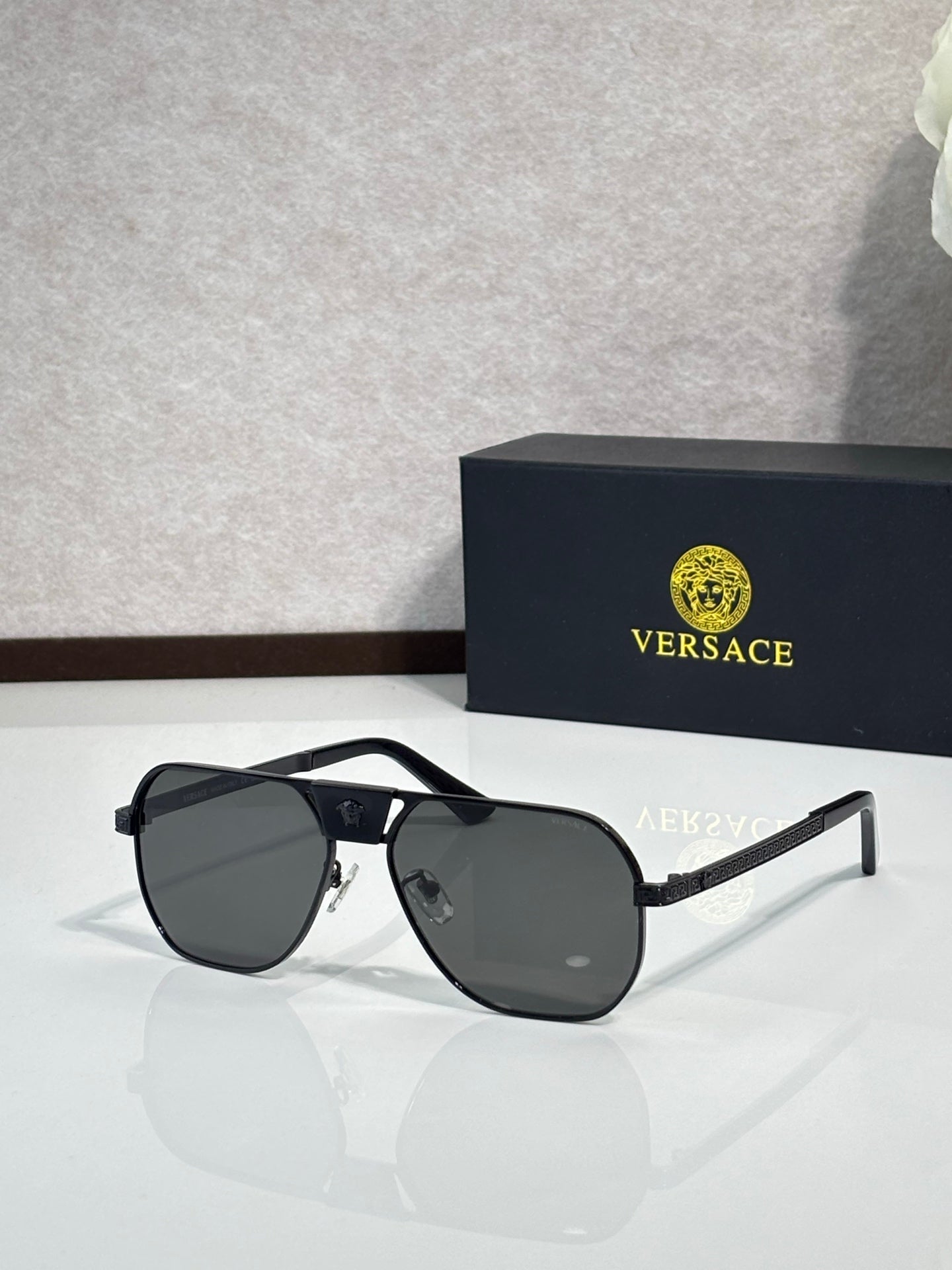 Versace sunglasses with black frame and dark lenses, square shield silhouette
