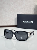 Chanel glasses with black frame and dark lenses, gold-tone logo detail