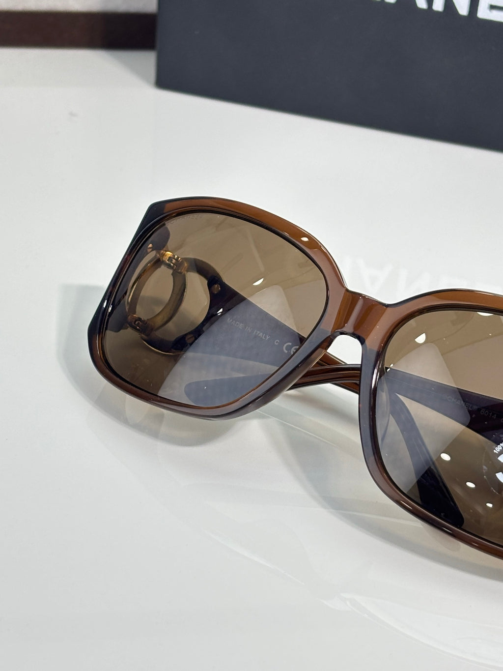 Chanel glasses side profile with tortoiseshell frame and tinted amber lenses