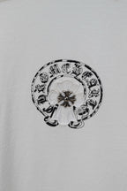 Small circular emblem graphic on a white chrome short T-shirt