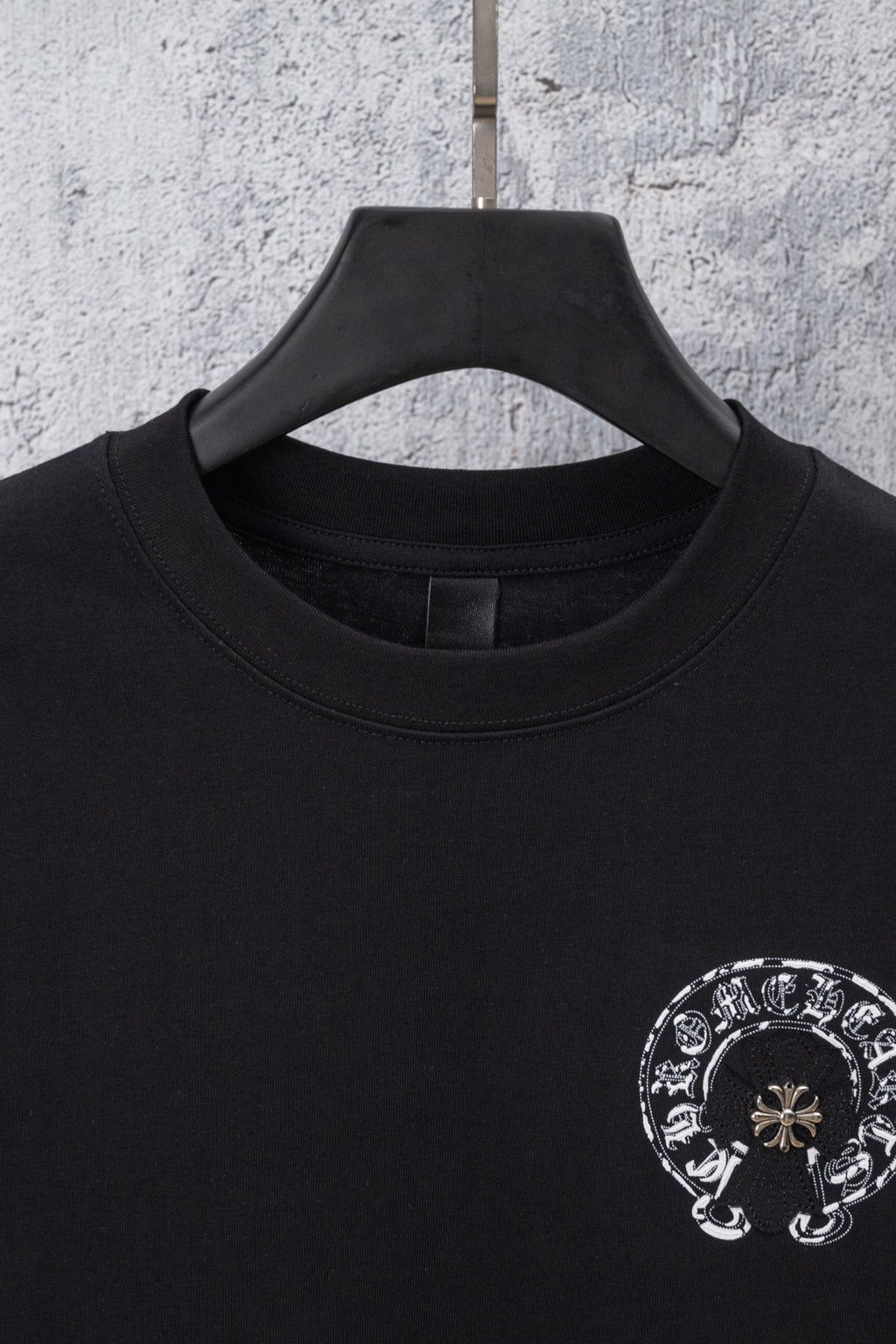 Black crewneck t-shirt with circular chrome-style graphic