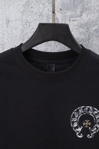 Black crewneck t-shirt with circular chrome-style graphic