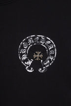 Black chrome short T-shirt with small circular emblem graphic