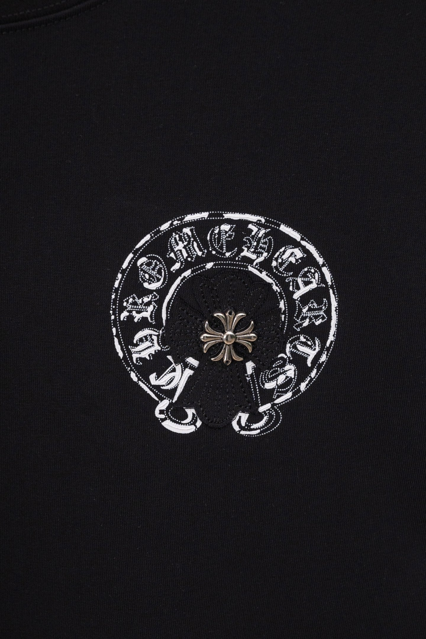 Black chrome short T-shirt with small circular emblem graphic