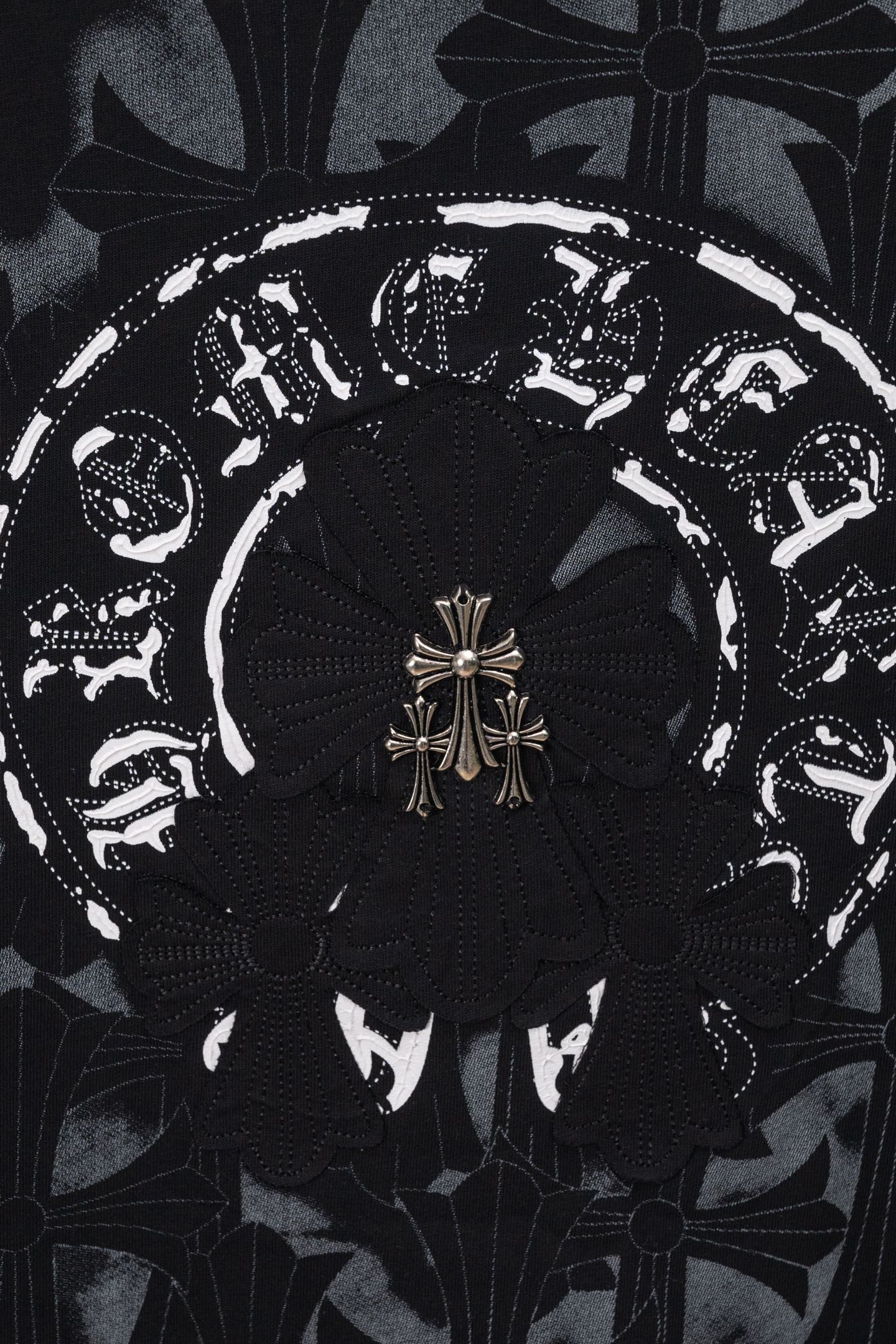 Black chrome short T-shirt close-up of ornate circular emblem center design