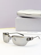 Square-edge sunglasses with clear dark lenses and metallic gold bridge detail