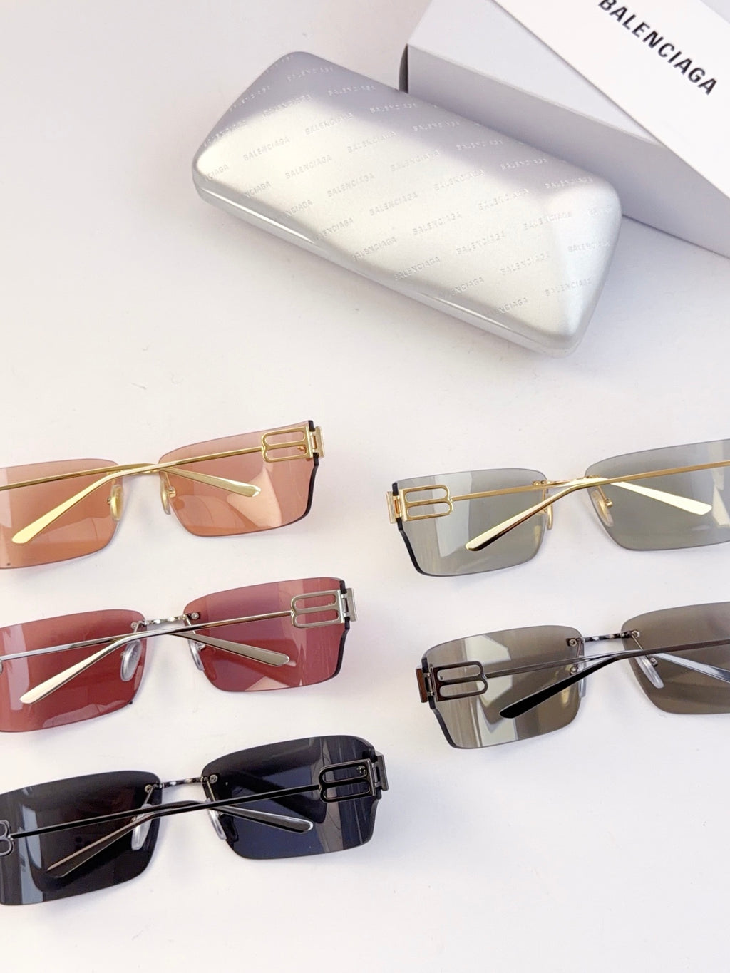 Assorted sunglasses laid out, including tinted amber and clear gray frames