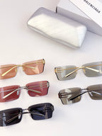 Assorted sunglasses laid out, including tinted amber and clear gray frames