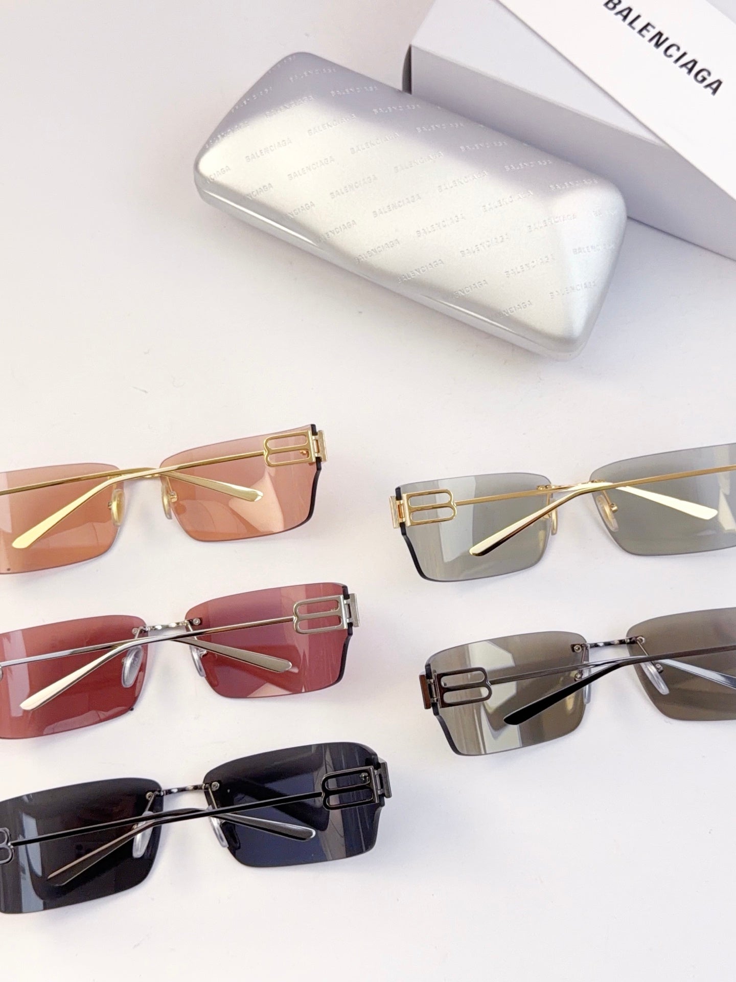 Assorted sunglasses laid out, including tinted amber and clear gray frames