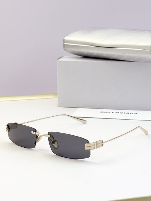 Balenciaga sunglasses, dark gray lenses with gold-tone bridge detail